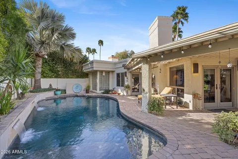 a view of a house with swimming pool and sitting area