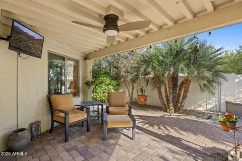 a building outdoor space with patio furniture and potted plants