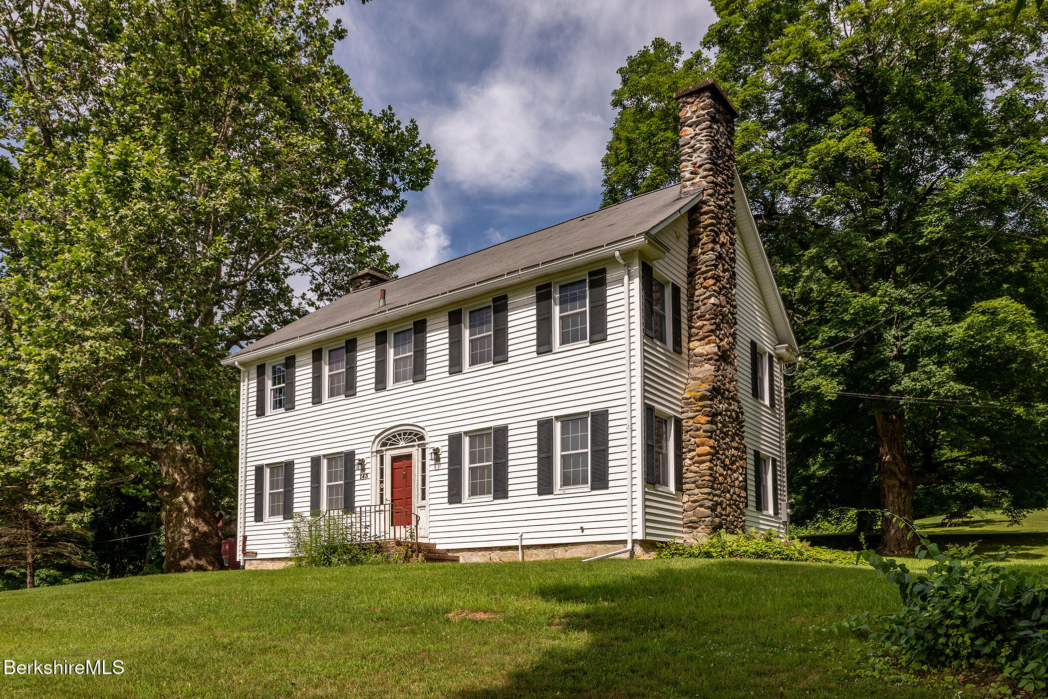 143 White Hollow Road Salisbury, CT 06039 - Photo 2 of 36 a front view of a house with a garden