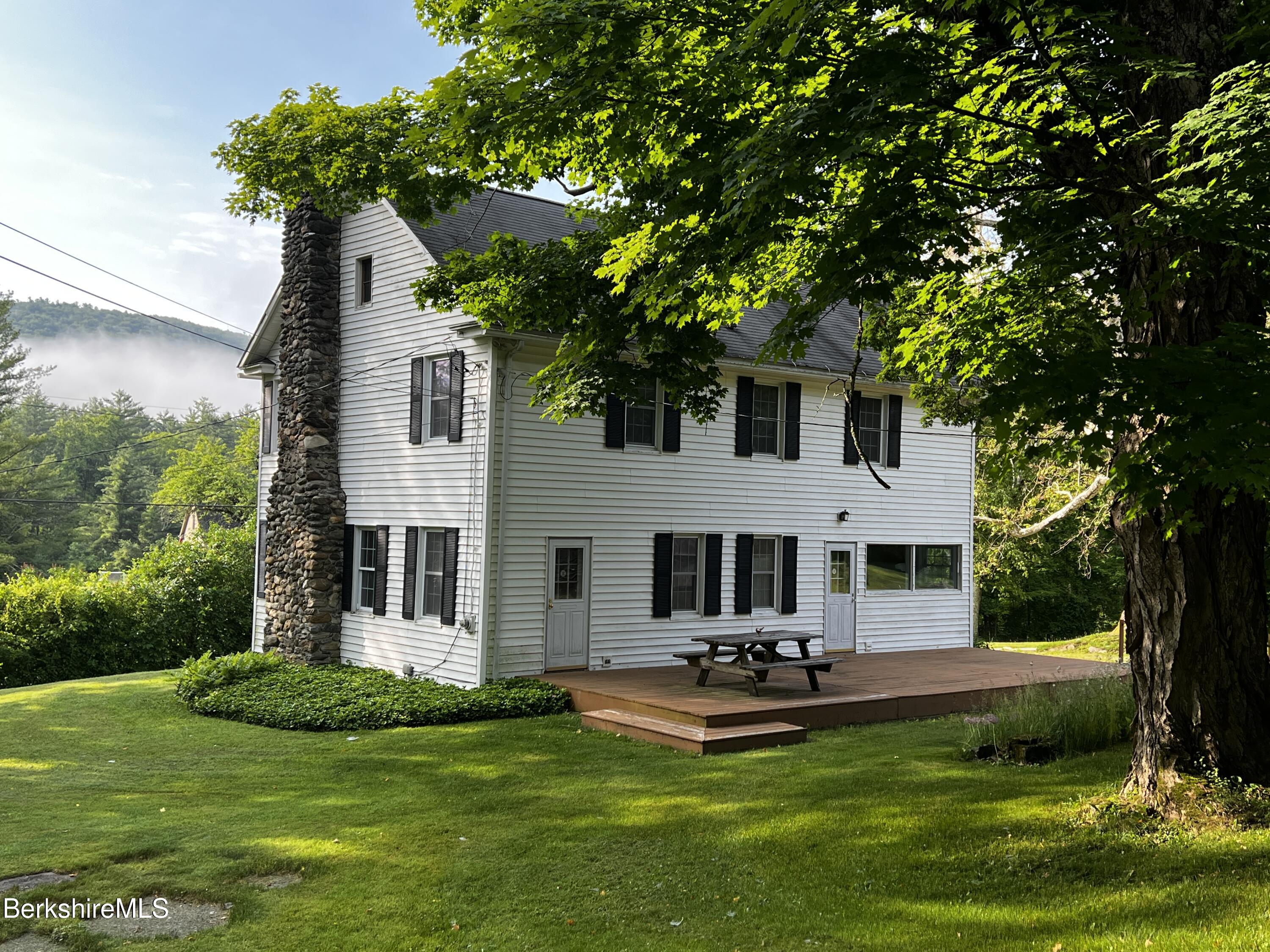 143 White Hollow Road Salisbury, CT 06039 - Photo 22 of 36 a front view of a house with yard and green space
