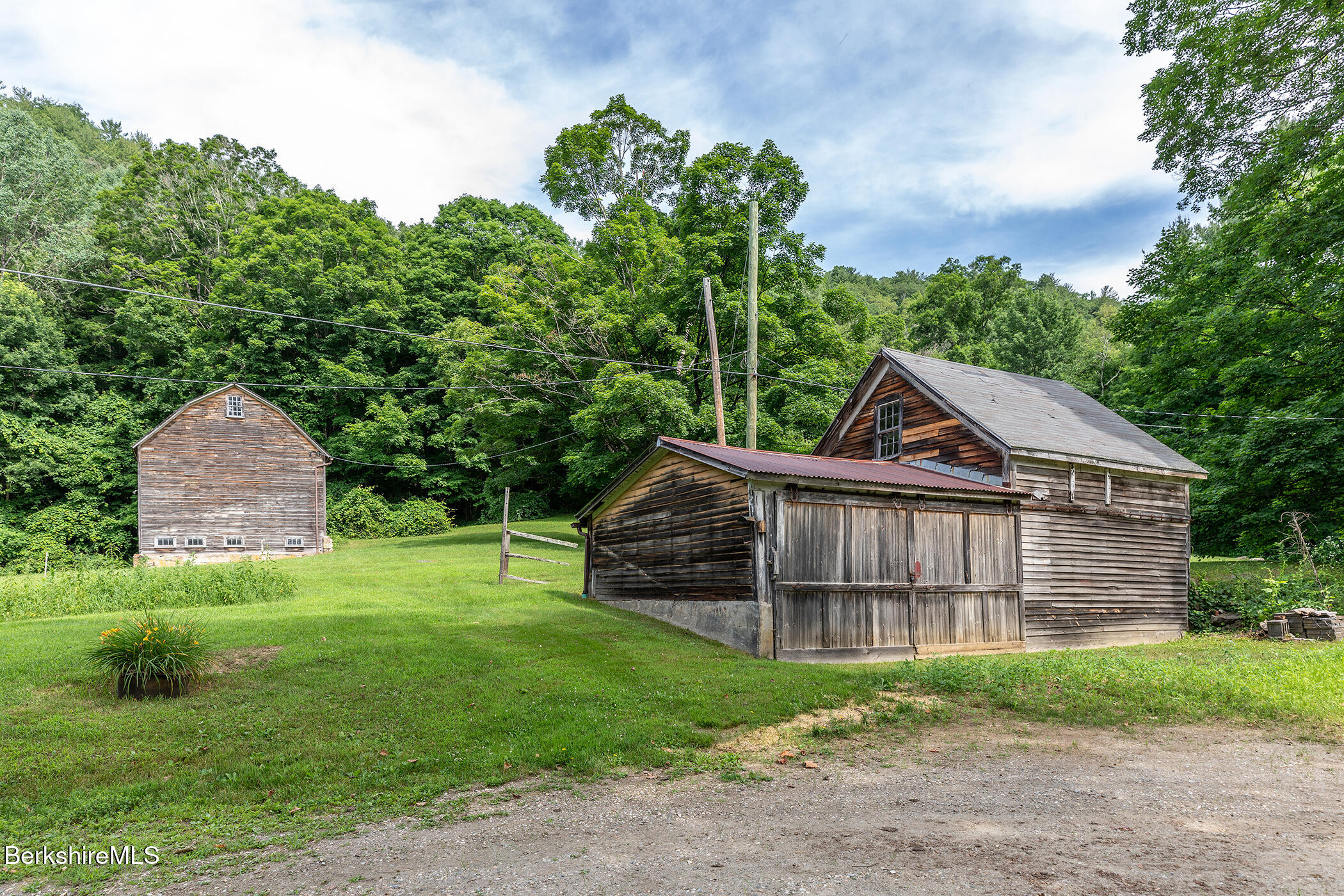 143 White Hollow Road Salisbury, CT 06039 - Photo 24 of 36 a view of a wooden house with a big yard and large trees