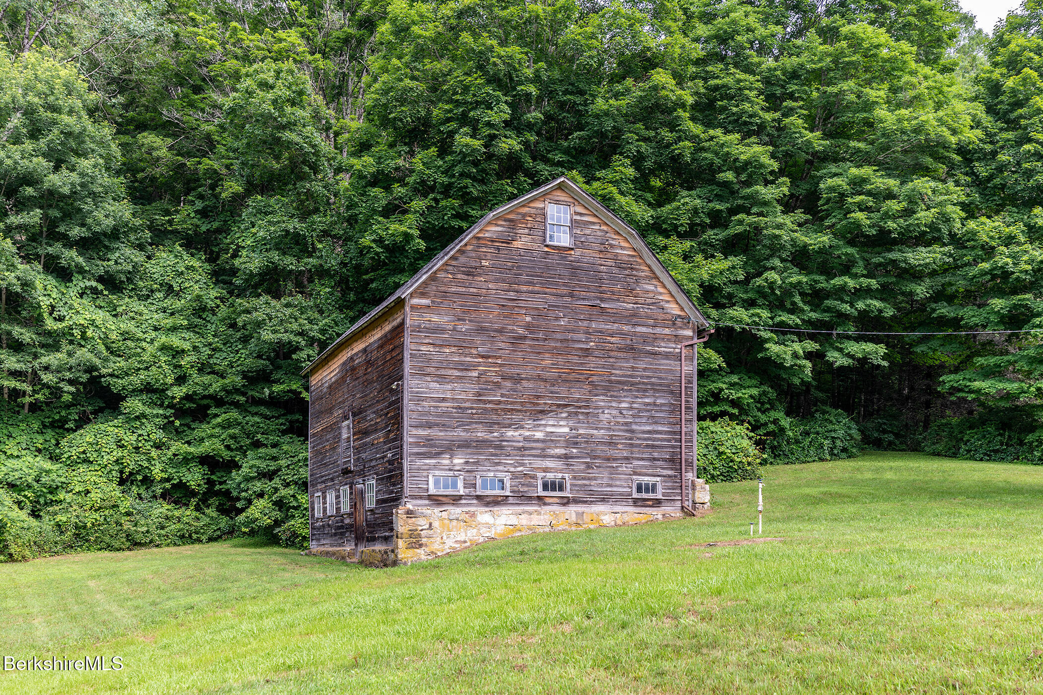 143 White Hollow Road Salisbury, CT 06039 - Photo 25 of 36 a view of a backyard with potted plants and large tree