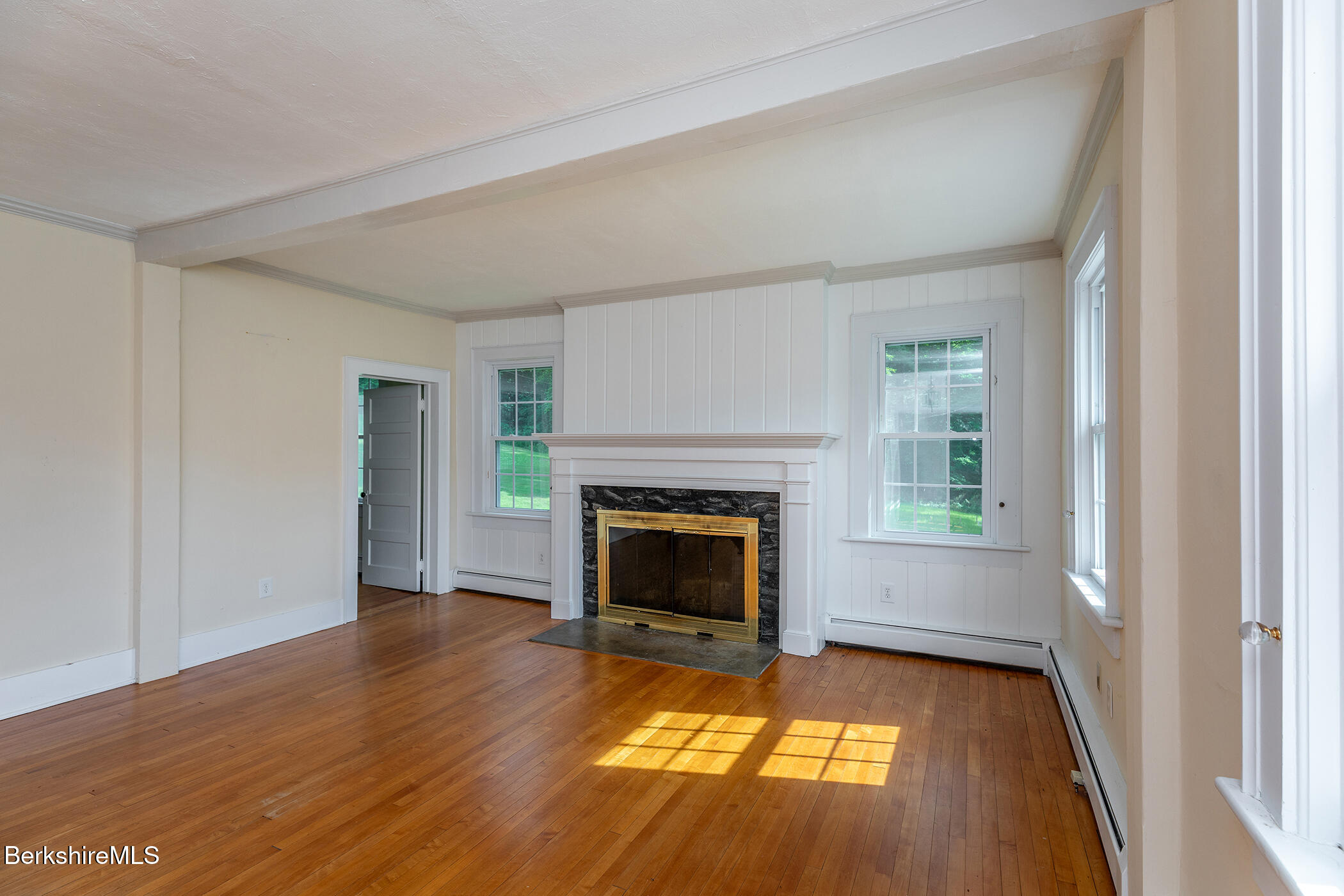 143 White Hollow Road Salisbury, CT 06039 - Photo 5 of 36 a view of an empty room with wooden floor fireplace and a window