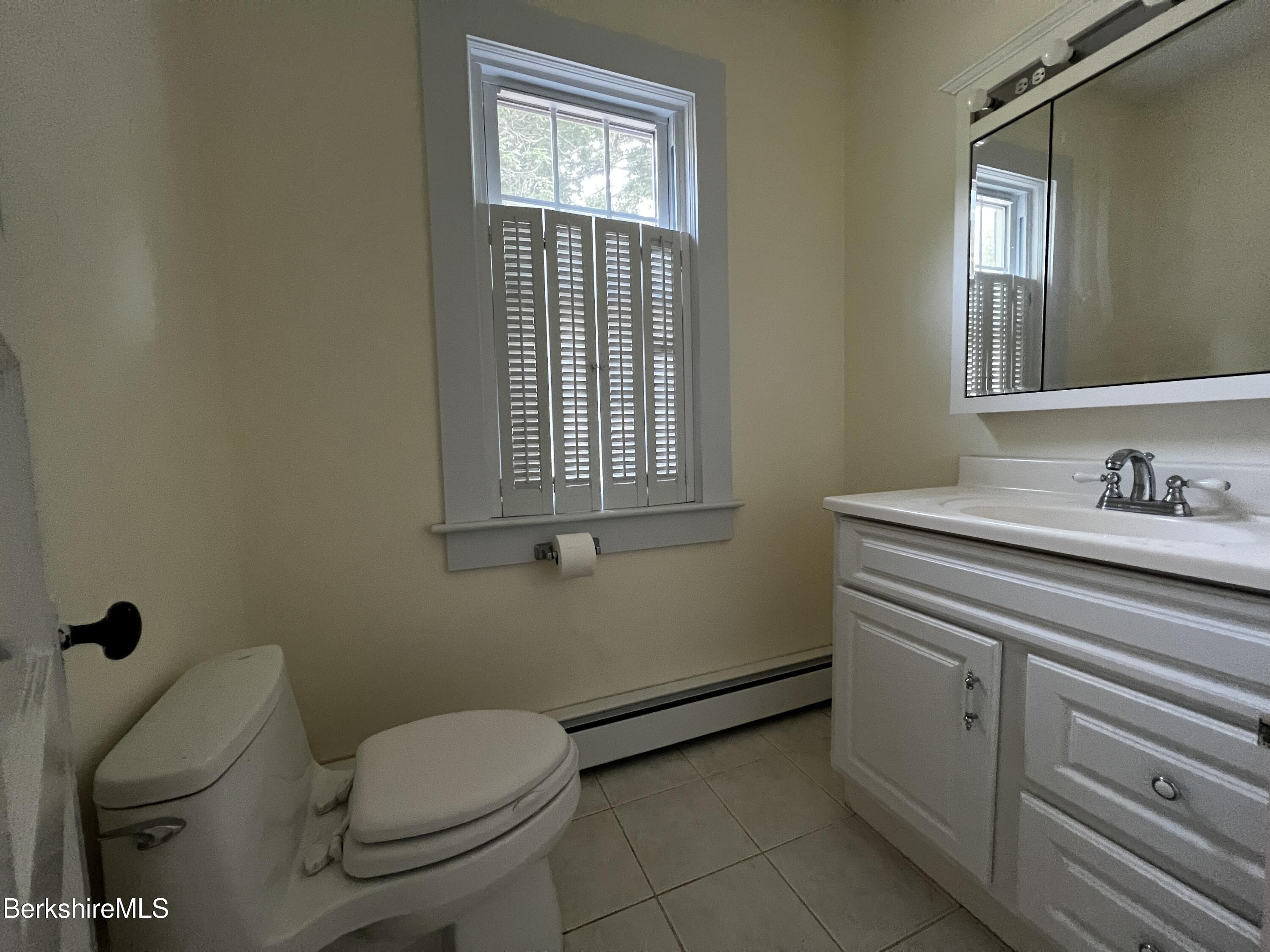 143 White Hollow Road Salisbury, CT 06039 - Photo 10 of 36 a bathroom with a toilet sink and mirror