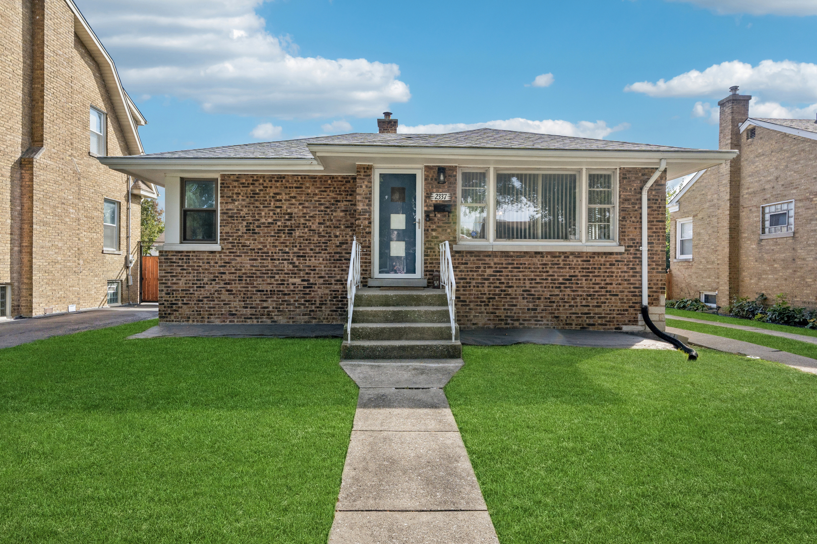 a front view of a house with garden