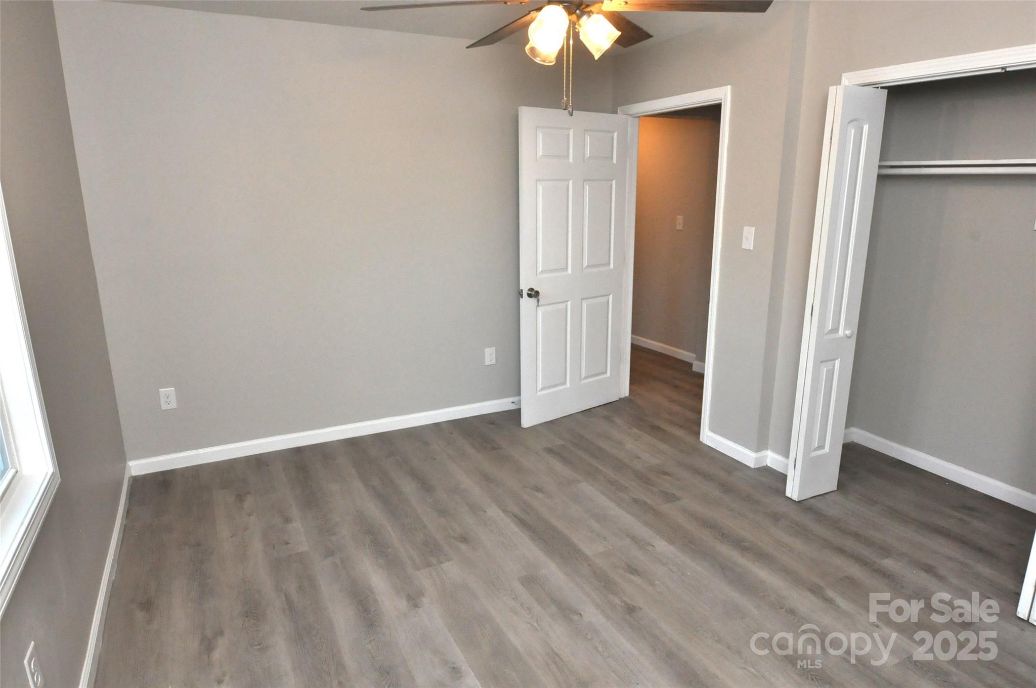 538 2nd Street Chester, SC 29706 - Photo 11 of 17 an empty room with wooden floor chandelier fan and window