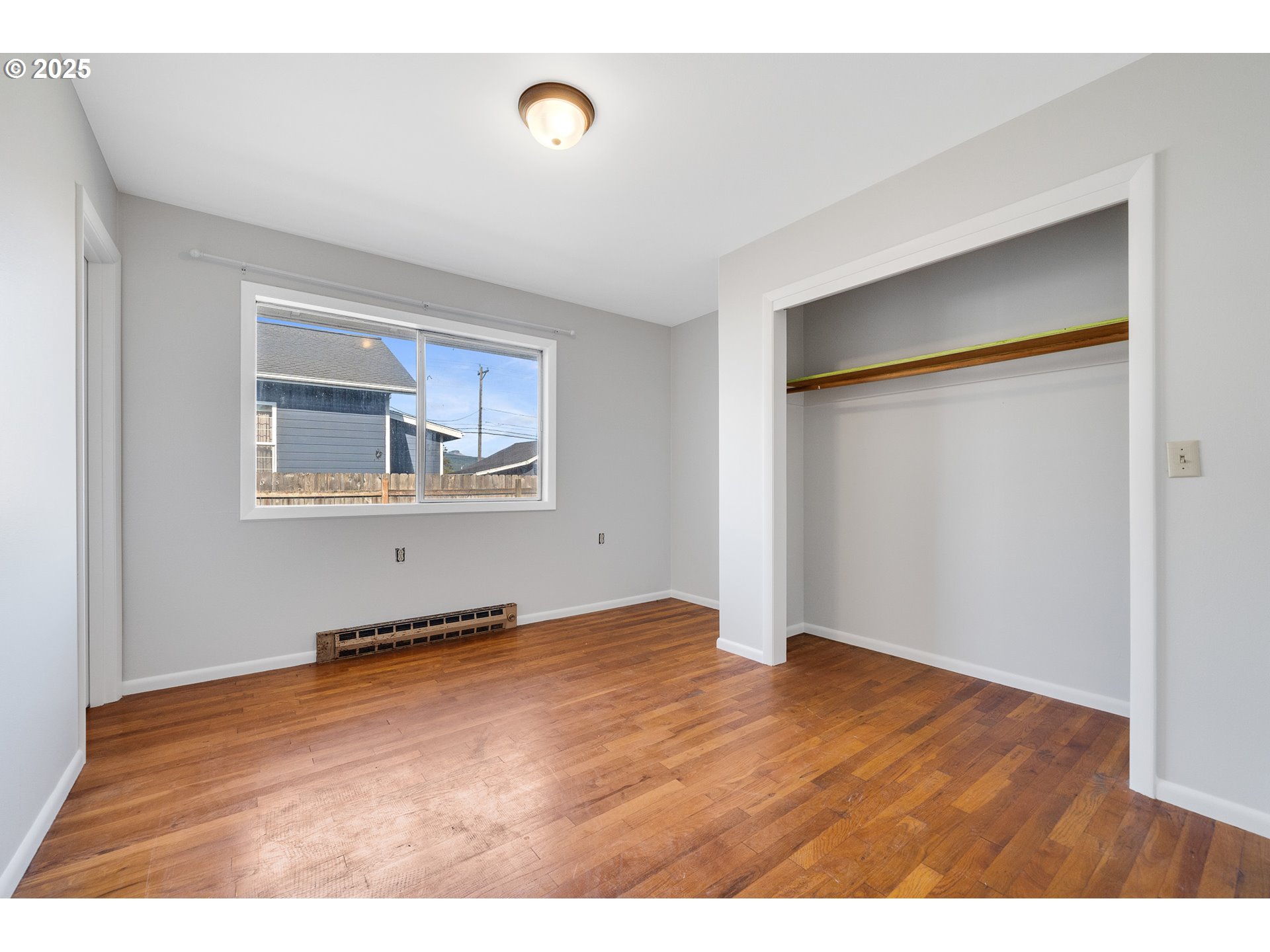 1806 8th Street Tillamook, OR 97141 - Photo 13 of 31 a view of an empty room with wooden floor and a window