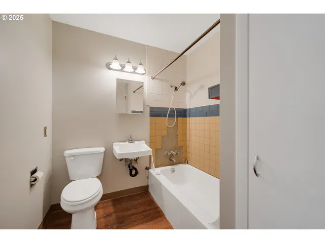 a bathroom with a toilet a sink and bathtub