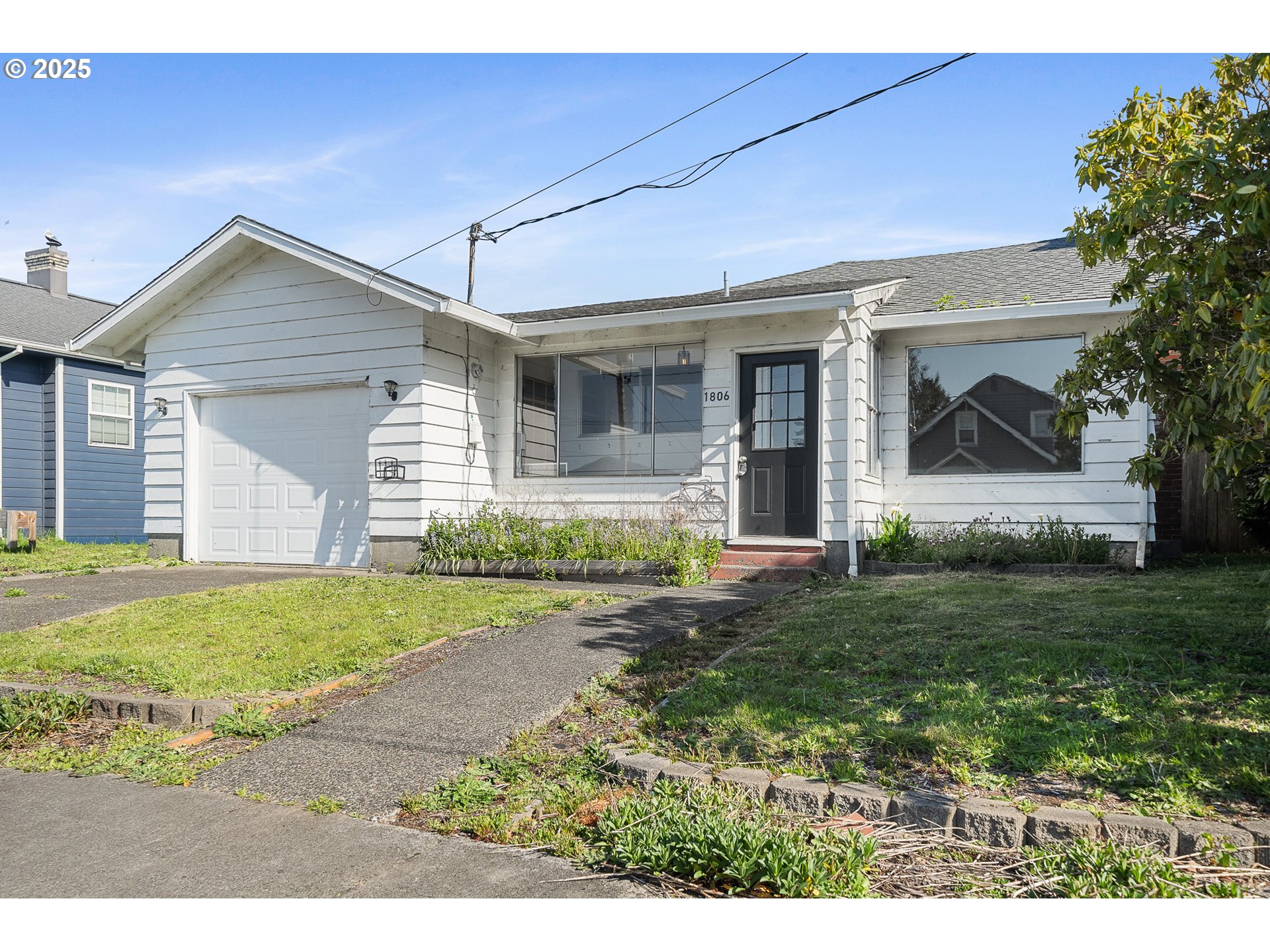 1806 8th Street Tillamook, OR 97141 - Photo 2 of 31 a view of a house with a yard and garage