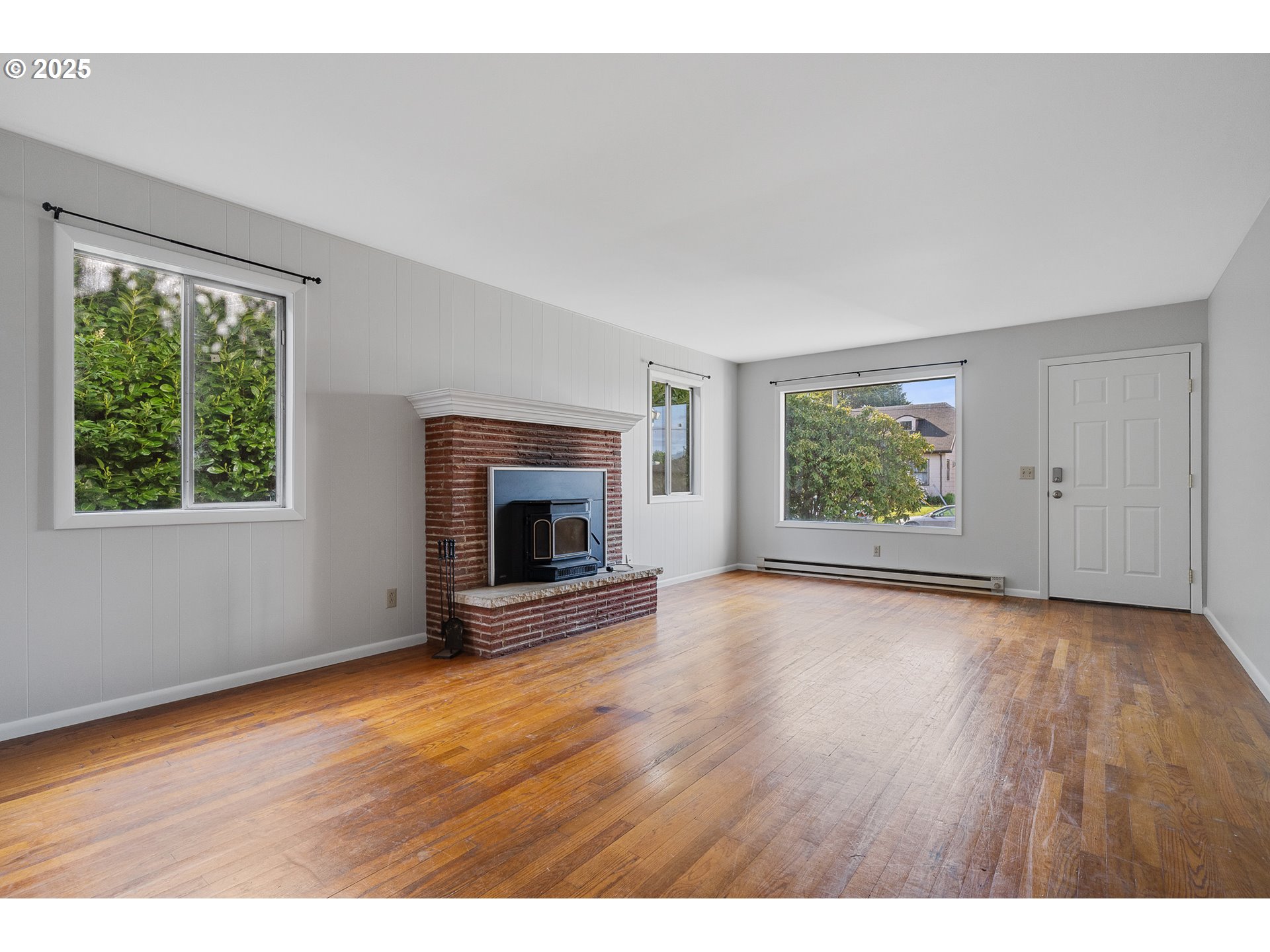 1806 8th Street Tillamook, OR 97141 - Photo 6 of 31 a view of an empty room with a window and wooden floor