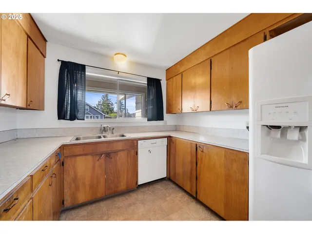 a large kitchen with a sink and cabinets