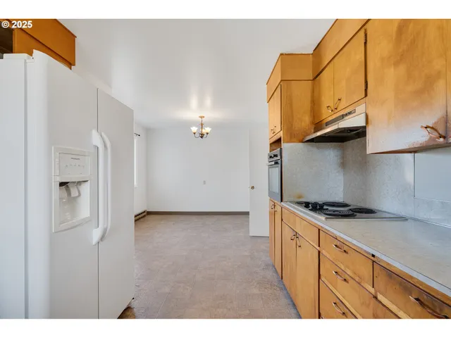a kitchen with stainless steel appliances granite countertop a stove and a refrigerator