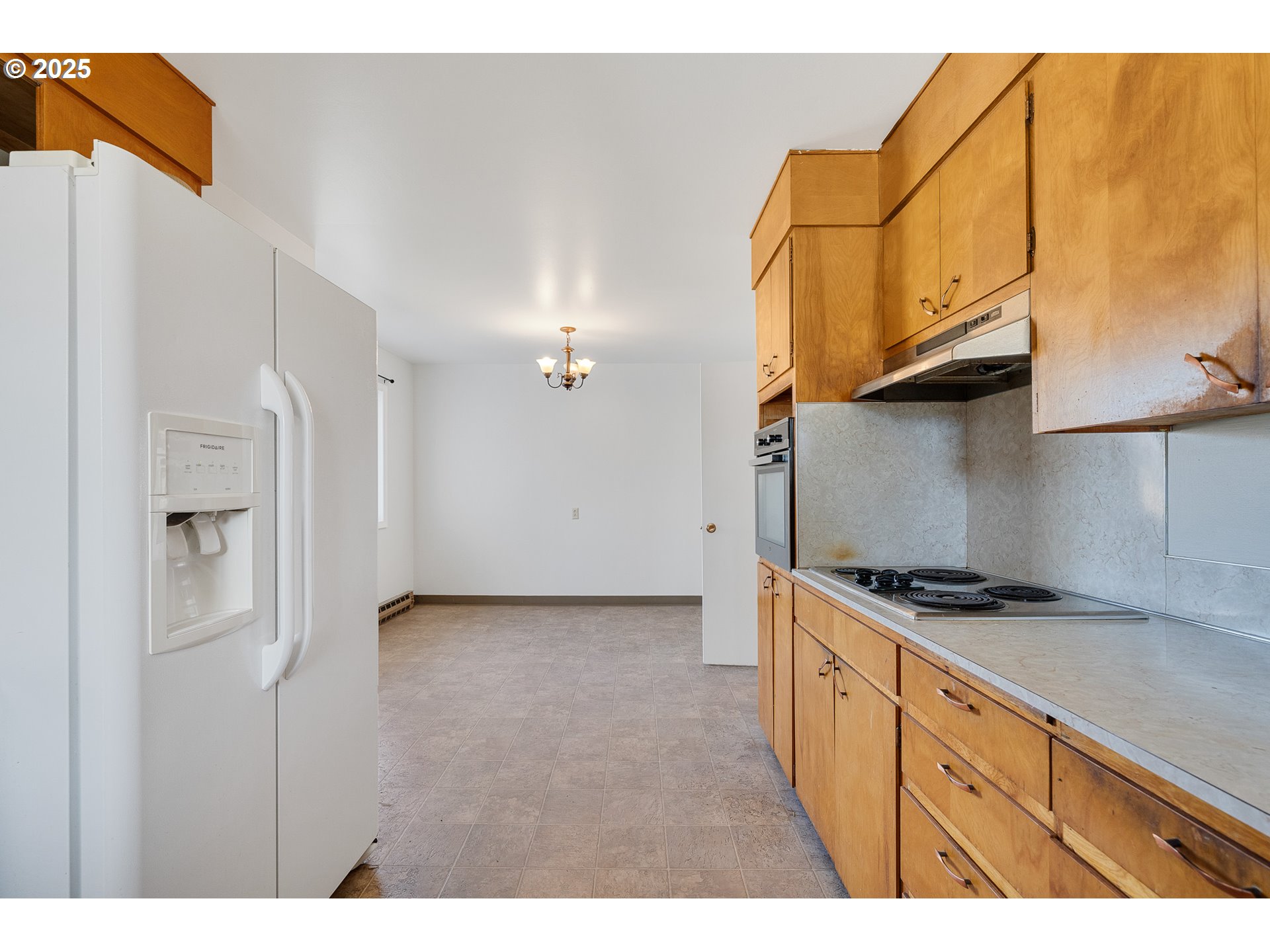 1806 8th Street Tillamook, OR 97141 - Photo 9 of 31 a kitchen with stainless steel appliances granite countertop a stove and a refrigerator