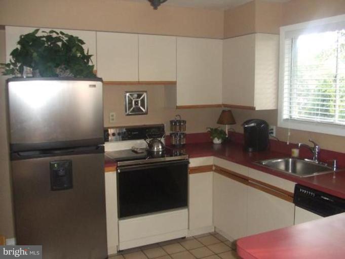 1818 Willann Road Rosedale, MD 21237 - Photo 12 of 25 a kitchen with stainless steel appliances granite countertop a sink stove and refrigerator
