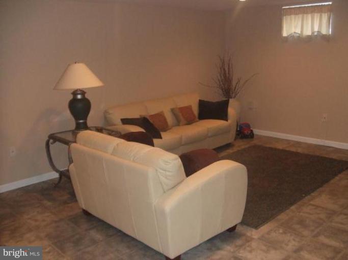 1818 Willann Road Rosedale, MD 21237 - Photo 15 of 25 a living room with furniture and a lamp
