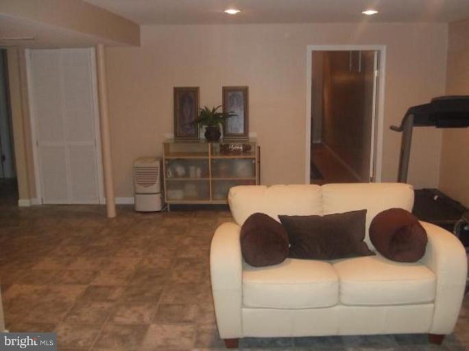 1818 Willann Road Rosedale, MD 21237 - Photo 16 of 25 a large bed sitting in a bedroom and a table