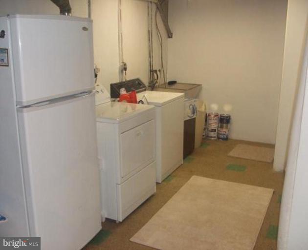 1818 Willann Road Rosedale, MD 21237 - Photo 22 of 25 a utility room with cabinets washer and dryer