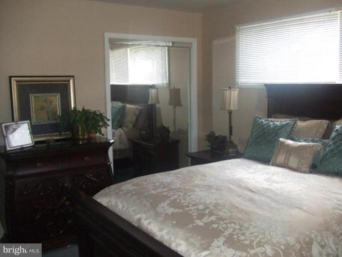 1818 Willann Road Rosedale, MD 21237 - Photo 8 of 25 a bedroom with a bed and a potted plant