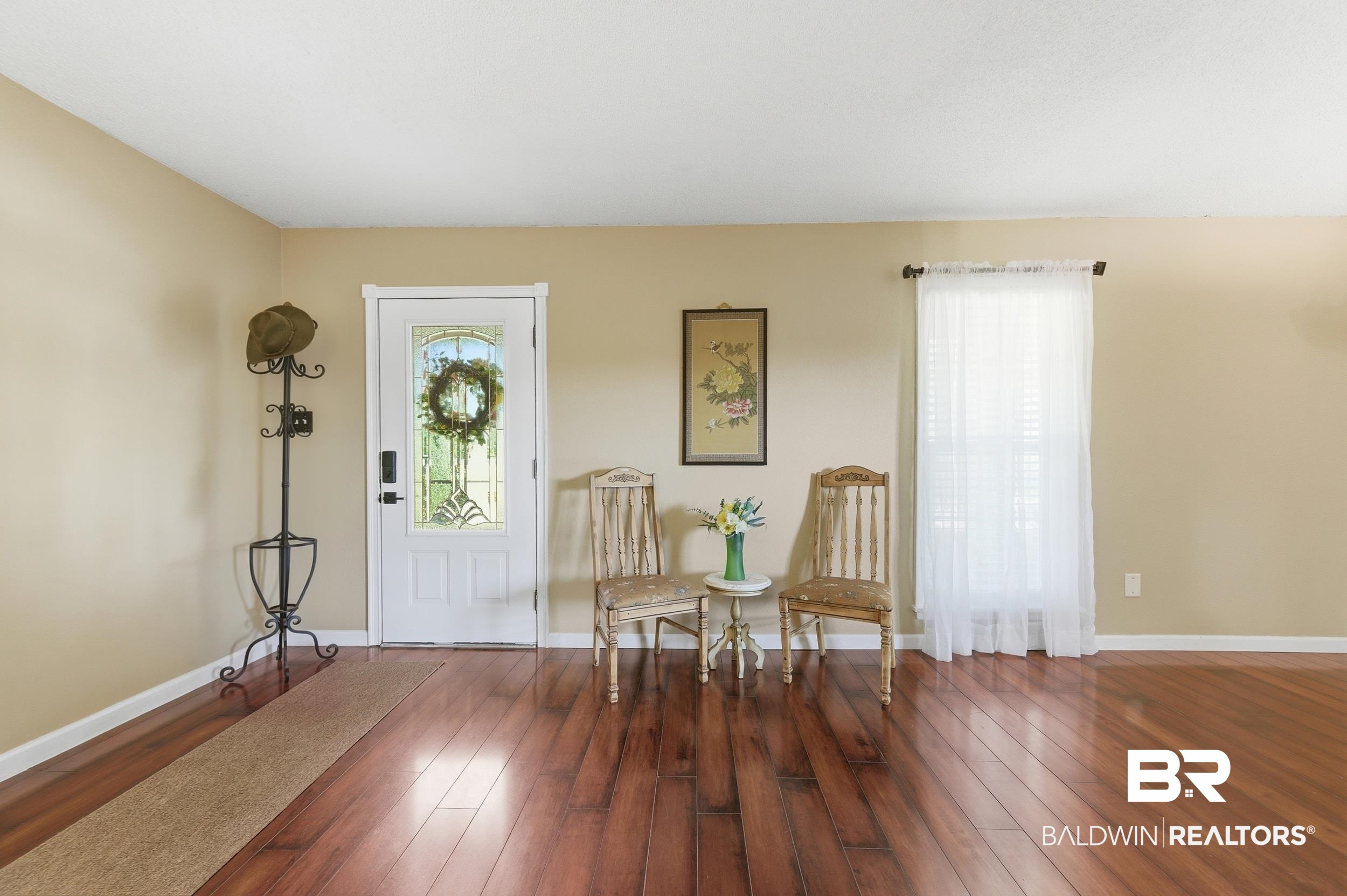 51620 Robert White Road Bay Minette, AL 36507 - Photo 12 of 81 Entryway featuring rich wood-finish flooring, a white paneled door with decorative glass inserts, and a single window with white trim