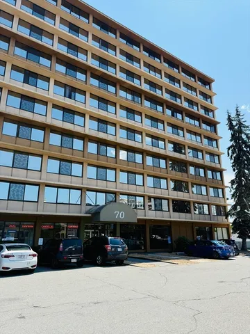 a view of building with car parked