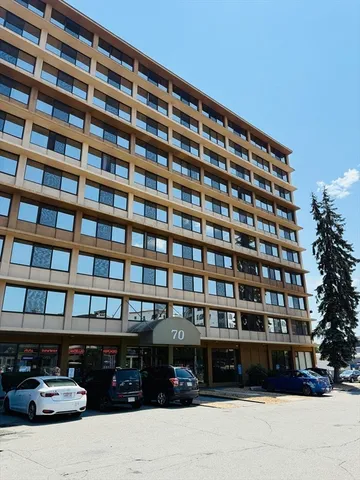 a front view of a building with parking