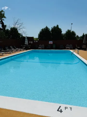 a view of swimming pool and outdoor seating