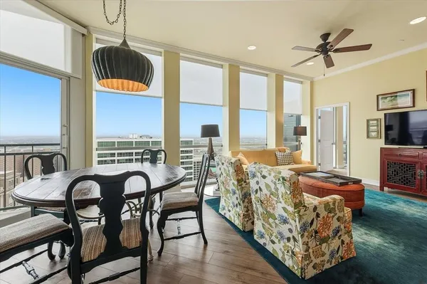 a living room with furniture and a floor to ceiling window