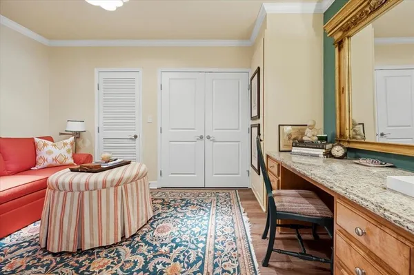 a bedroom with a bed and a table chair