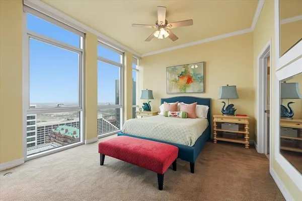 a spacious bedroom with a bed and a couch