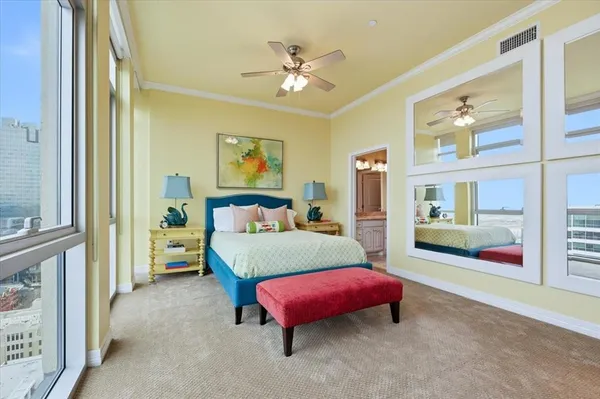 a bedroom with a bed and a chandelier