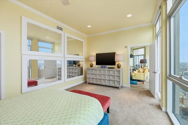 a bedroom with bed and flat screen tv