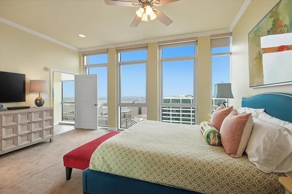 a bedroom with a bed and walk in closet with wooden floor