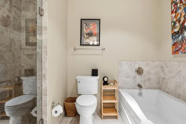 a white toilet sitting next to a bathroom sink and tub