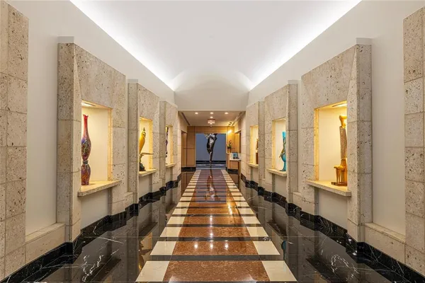 a view of a hallway with large windows