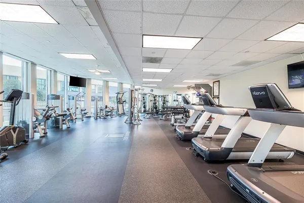 a living room with lots of furniture and gym equipment