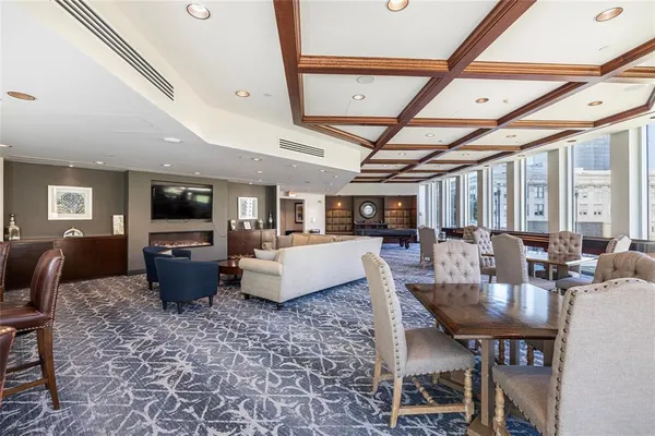 a living room with furniture a flat screen tv and a table