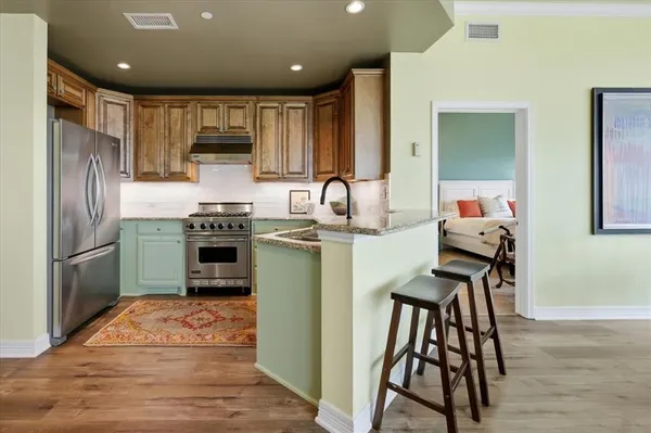 a kitchen with kitchen island a counter top space appliances and cabinets