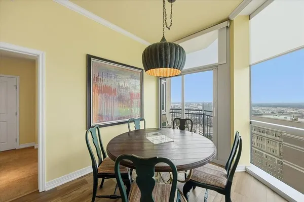 a view of a dining room with furniture window and wooden floor