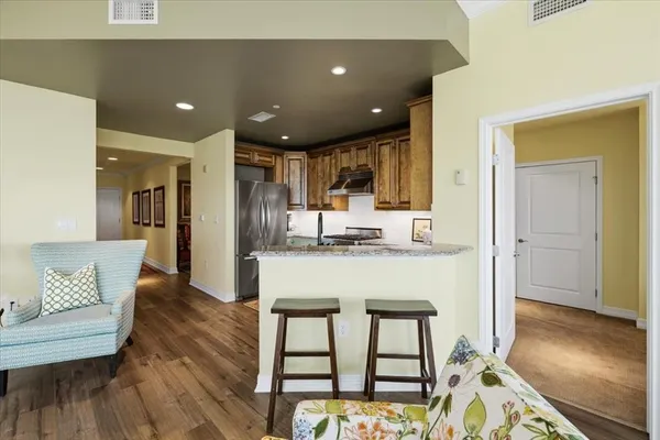 a view of kitchen with granite countertop window dining table and chairs