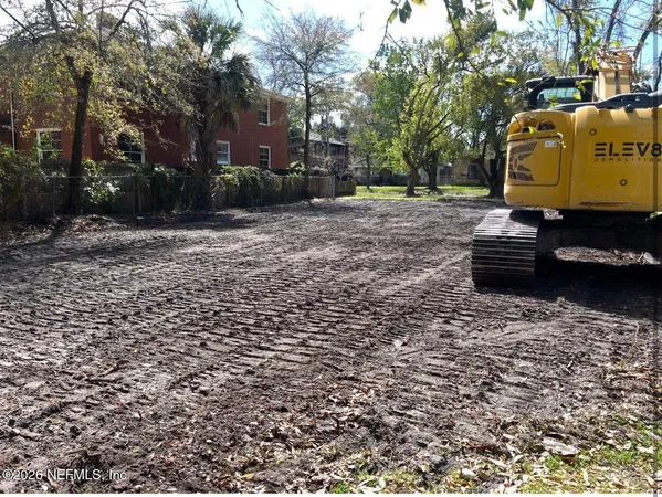a backyard of a house with barbeque oven
