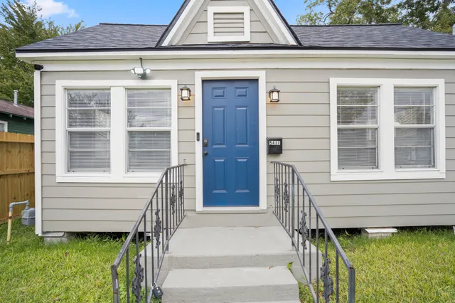 a front view of a house with a garden