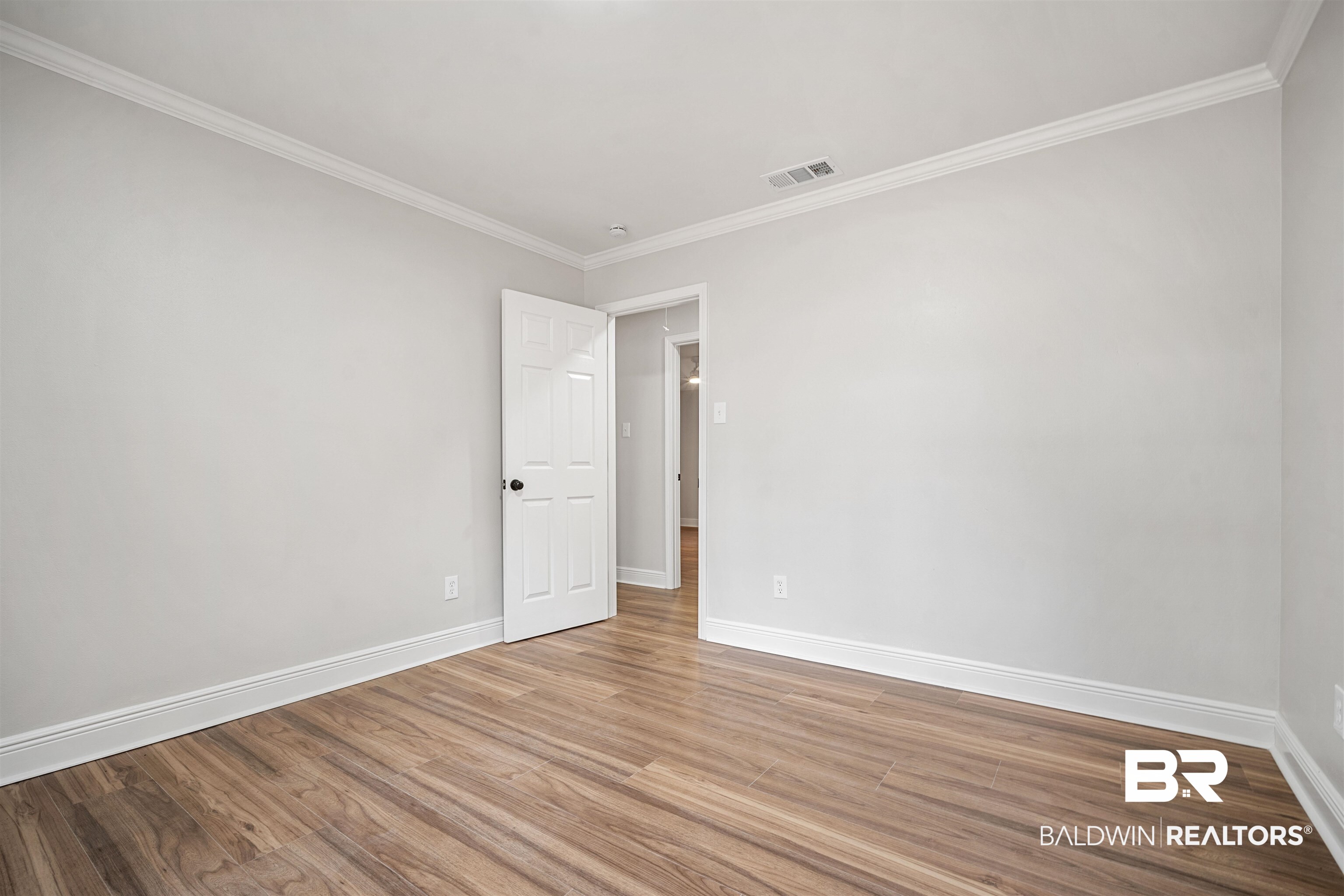 3050 Lacoste Road Mobile, AL 36618 - Photo 20 of 30 Unfurnished room featuring crown molding and wood finished floors