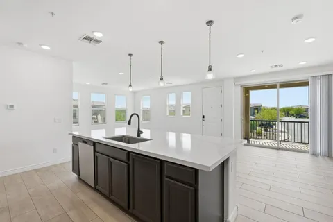 a kitchen with stainless steel appliances granite countertop a stove a refrigerator and a microwave