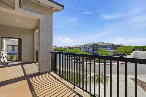 a view of a terrace with couches and wooden fence