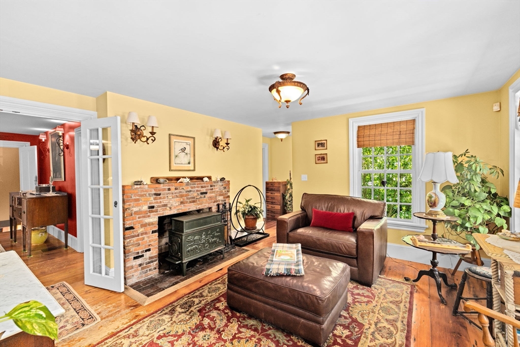 71 High Street Canton, MA 02021 - Photo 14 of 42 a living room with furniture a flat screen tv and a table