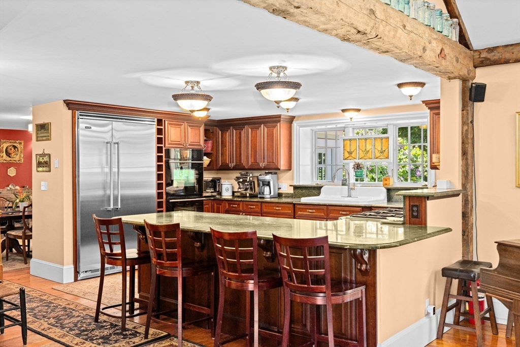 71 High Street Canton, MA 02021 - Photo 5 of 42 a large kitchen with a table and chairs
