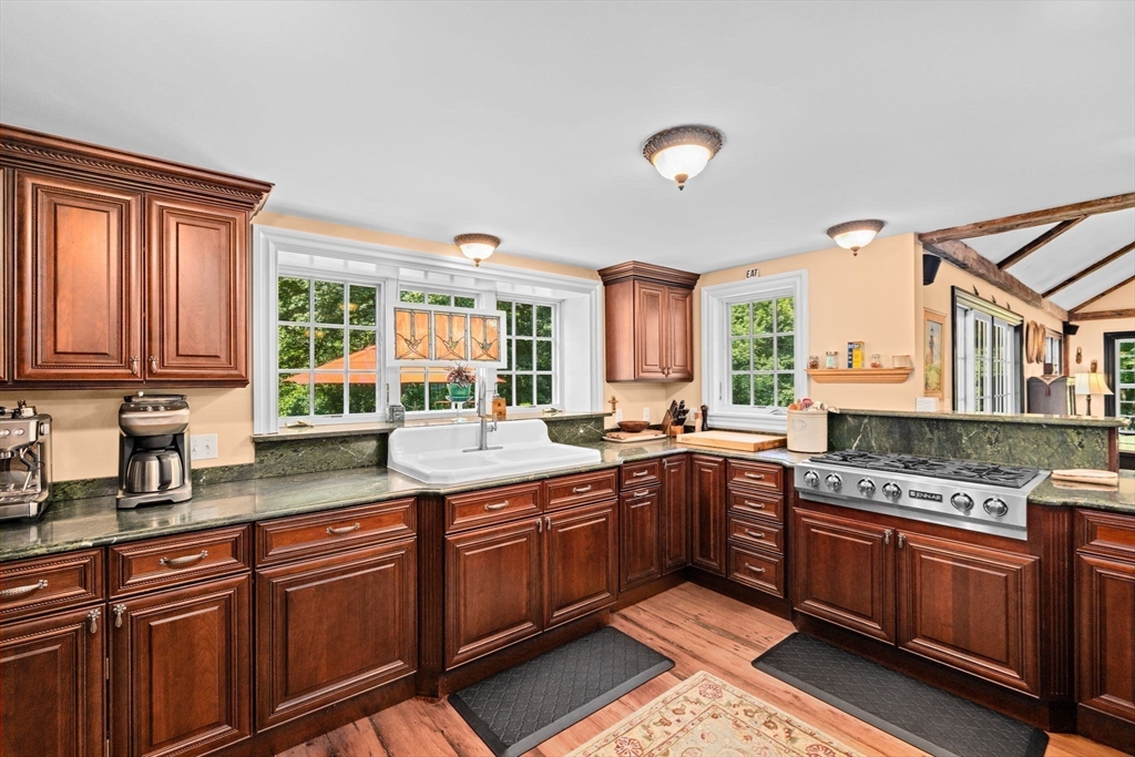 71 High Street Canton, MA 02021 - Photo 6 of 42 a kitchen with stainless steel appliances granite countertop a stove a sink and a microwave