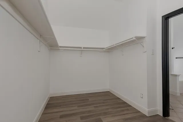 a view of a room with wooden floor