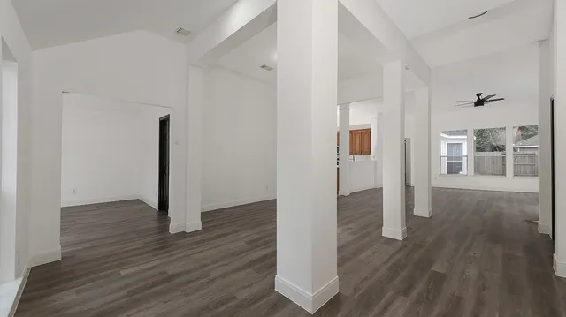 a view of a hallway with wooden floor