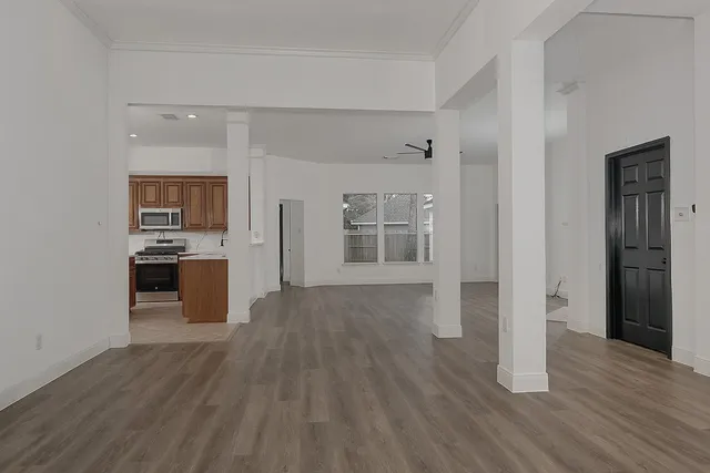 a view of a kitchen with wooden floor and a kitchen